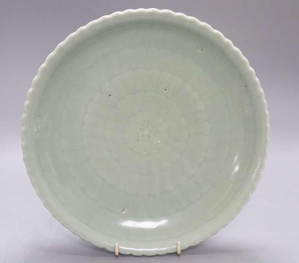 A Chinese celadon glazed dish, 18th / 19th century, Qianlong mark, diameter 28cm